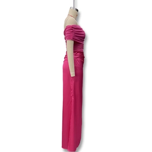 Detail view of pink off-shoulder dress featuring side ruching and satin fabric texture