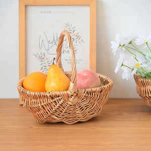 Detailed close-up of a handmade woven fruit basket with sturdy handle and fresh fruits