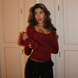 Detail view of burgundy slim-fit long sleeve top with delicate eyelash lace trim and square neck