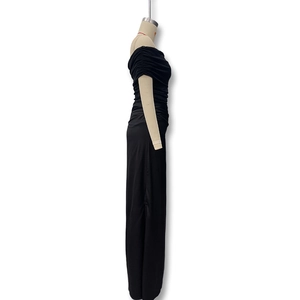 Detail of black off-shoulder maxi dress featuring ruched mesh fabric and a slim fit cut