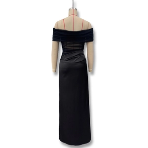 Detail of off-shoulder mesh stitching and layered pleats on elegant black evening dress