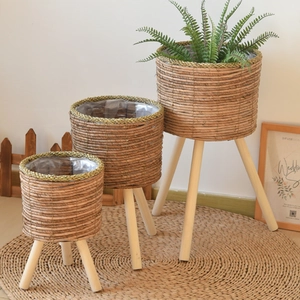 Three-piece woven plant stand set with natural seagrass baskets and solid wood tripod legs