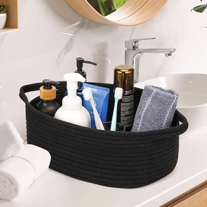 Detail of black cotton rope woven basket containing various toiletries on a bathroom counter