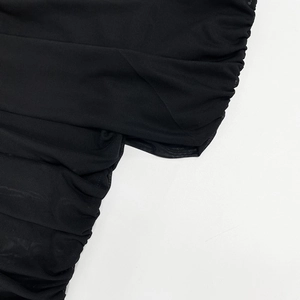 Detail of sheer black mesh stitching with vertical ruching on a sexy summer dress