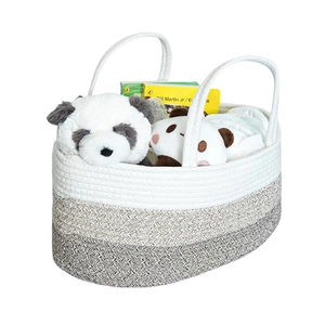 Detailed texture of tricolor cotton rope baby caddy with diapers and panda toy inside