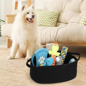 Detailed view of black oval woven cotton rope storage basket with pets toys