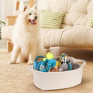 Close-up of woven cotton rope storage basket filled with plush pet toys in a home setting