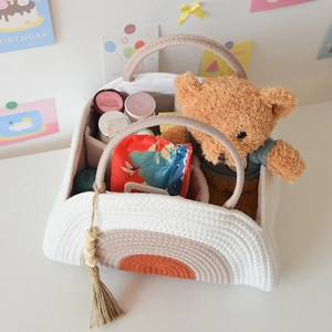 Overhead view of cotton rope diaper caddy with dividers showing baby essentials storage