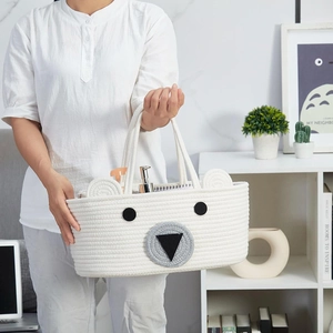 Macro view of portable cotton rope diaper basket with cute 3D bear face embroidery