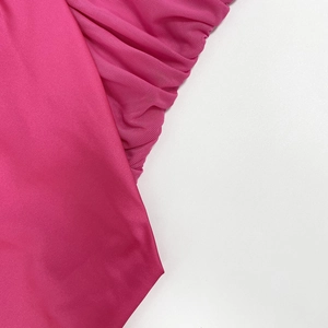 Close-up of rose purple silk satin and sheer mesh fabric textures for evening dresses