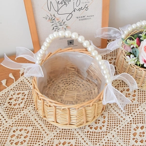 Handwoven willow flower basket with pearl handle and white organza bows for wedding