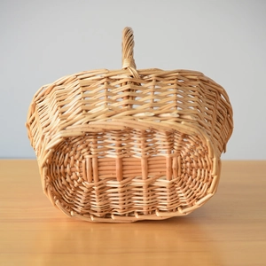 Close-up of the handcrafted rattan weave texture and sturdy reinforced handle