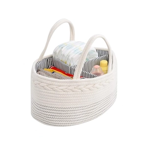 Close-up of portable cotton rope diaper caddy with striped lining and three inner compartments