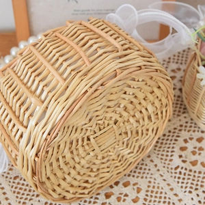 Close-up of hand-woven round wicker flower basket featuring intricate natural willow texture