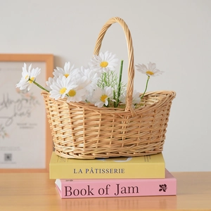 Rustic handmade wicker basket with flowers on books in a cozy warm setting