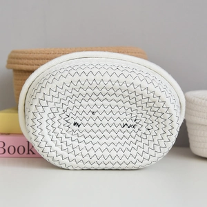 Close-up of handwoven cotton rope tissue box showing spiral texture and stitching