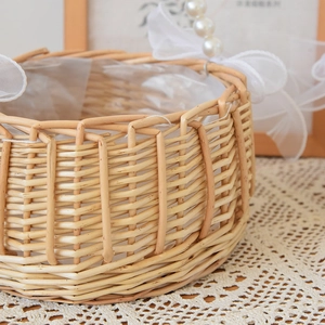 Close-up of hand-woven willow flower basket featuring lace bows and waterproof lining