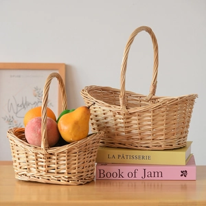 Detail of handcrafted willow storage baskets with high curved handles and tight weave