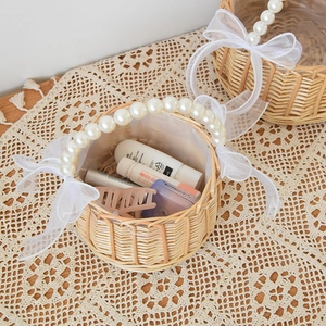 Handwoven basket with pearl handle and white organza bows for wedding petals or storage