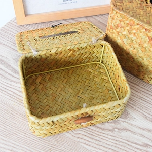 Macro shot showing woven texture and button detail of a straw facial tissue box