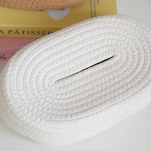 Close-up of white woven cotton rope tissue box cover with spiral braided texture