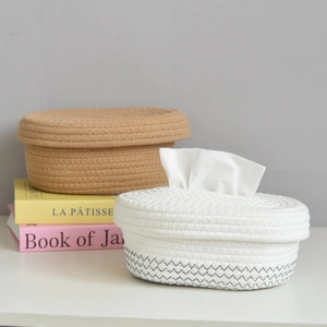 Detail of woven cotton rope tissue box with wooden lid and minimalist storage baskets