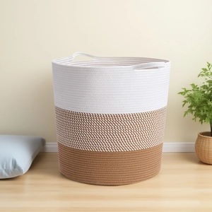 Detailed close-up of a three-color woven cotton rope storage basket with built-in handles