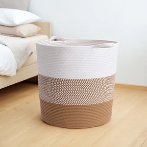 Detail of Nordic woven cotton rope storage basket with three-color stitching and handles