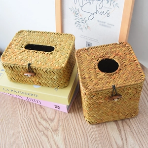 Close-up of handmade woven tissue box featuring natural grass texture and wooden button closure