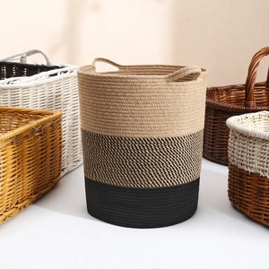 Detail of a large Nordic cotton rope storage basket with dual handles and three-tone design