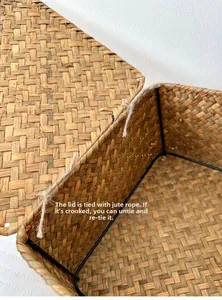 Detail showing natural seagrass weave texture and hemp rope hinge on the storage basket