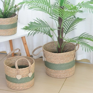 Detail view of woven sea grass plant baskets with green band and sturdy handles