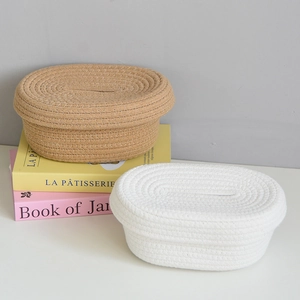 Detailed close-up of woven cotton rope tissue boxes in beige and khaki with lid