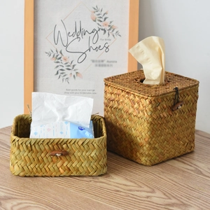 Detail of square straw tissue box with wood button closure and rectangular basket