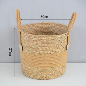 Detail of woven plant basket with gold glitters and side handles, height 27cm