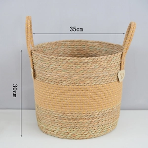 Detail view of woven seagrass basket with gold metallic thread and dimensions 35x30cm