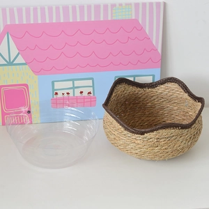 Close-up of Nordic hand-woven straw planter with waterproof plastic liner and leather trim