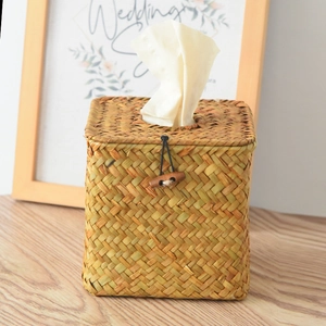 Handwoven square seagrass tissue box holder with wooden button in rustic home setting