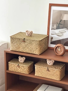 Detail of hand-woven seagrass storage baskets with lids and cute teddy bear ornaments