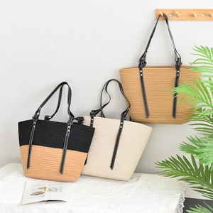 Large woven straw tote bag with leather handles in black and beige contrast design