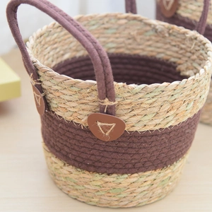 Detail of woven straw basket featuring reinforced leather handles and dual-tone texture