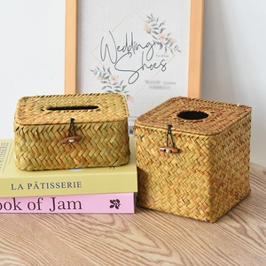 Close-up of handmade woven tissue box with natural straw texture and wood button closure