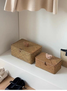 Detail of woven storage baskets featuring cute teddy bear handles and wooden buckle closure
