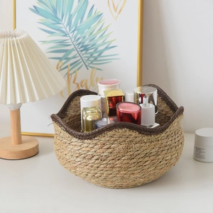 Nordic woven straw storage basket for plants and desk organization with wavy brown edges
