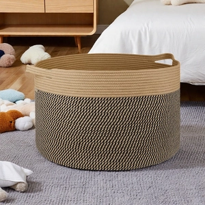Detail of Nordic cotton rope basket on grey carpet in a cozy home bedroom setting