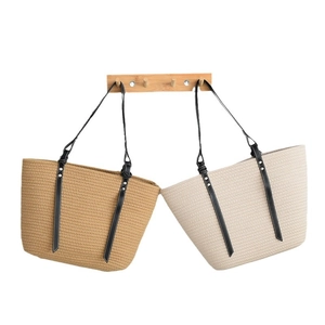 Minimalist large woven tote bag with leather straps in tan and off-white colors