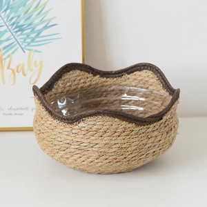 Detail of hand-woven seagrass planter with waterproof plastic lining and brown edge trim