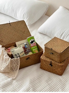 Three-piece set of woven seagrass storage baskets with lids used for bedroom organization