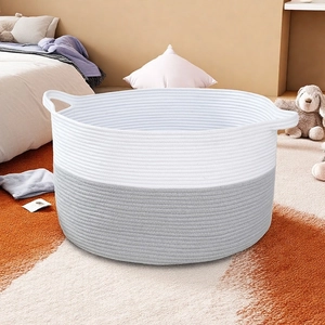 Close-up of dual-tone cotton rope storage basket with integrated handles in bedroom setting