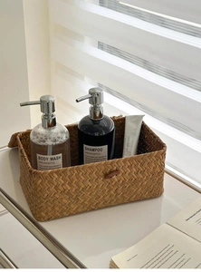 Detail of handwoven seagrass storage basket featuring a wooden button closure and rustic texture